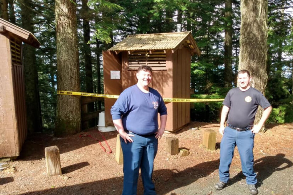 These two Firefighters rescued the woman from the vault toilet.