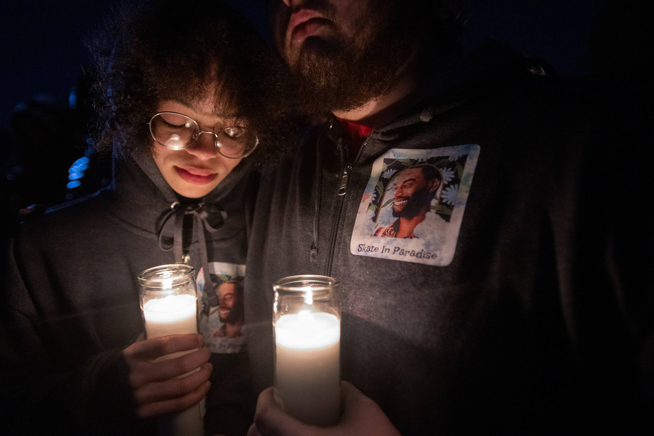 Candlelight illuminates a photo of Tyre Nichols during a vigil held by his family and friends at Regency Skate Park.