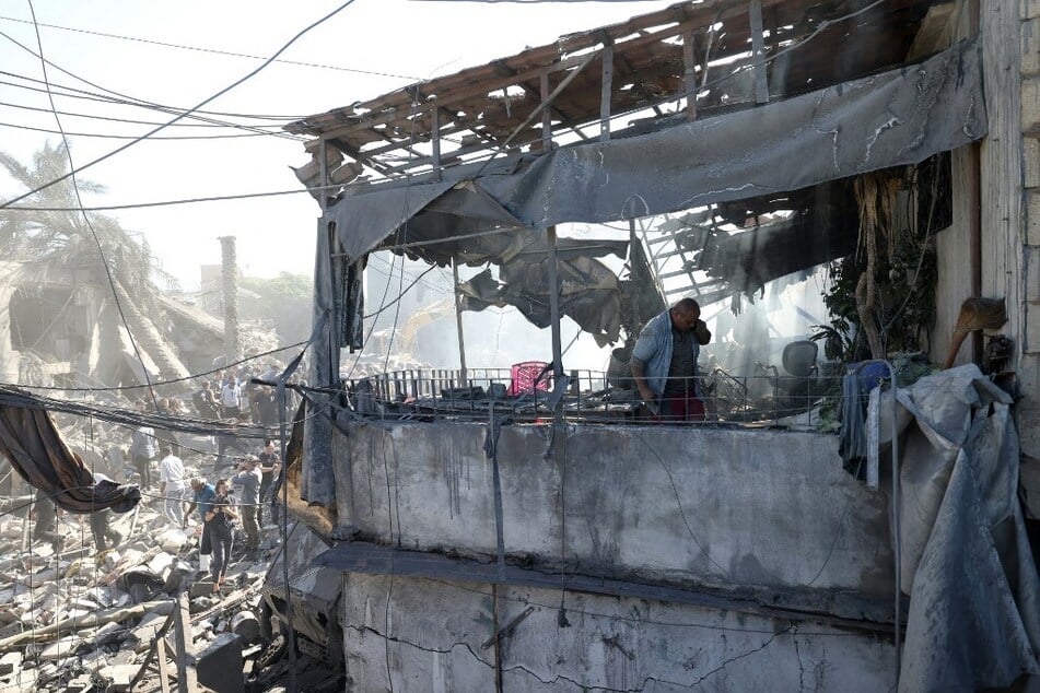 A Lebanese man inspects the debris a day after an Israeli airstrike in Beirut's southern suburb of Jnah on October 22, 2024.