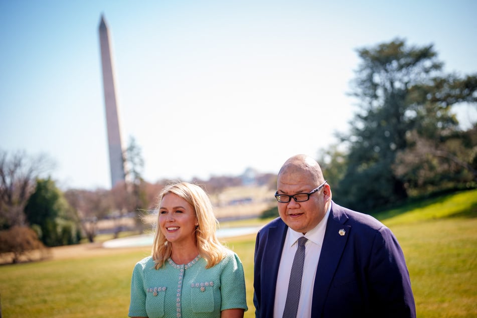 White House Press Secretary Karoline Leavitt (l.) and White House Communications Director Steven Cheung speak during an event on the South Lawn of the White House.