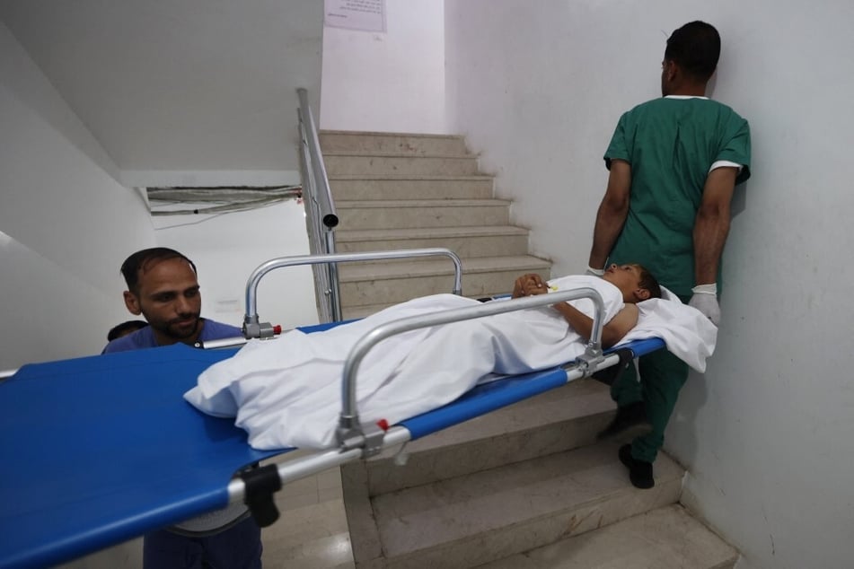 Medics care for patients at a clinic set up by Doctors Without Borders at the Rafah Indonesian Field Hospital in the southern Gaza Strip in April 2024.