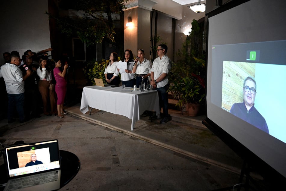 Former Honduras' President Juan Orlando Hernandez speaks via video call during a press conference hosted by his wife Ana Garcia de Hernandez in Tegucigalpa on April 8, 2026.