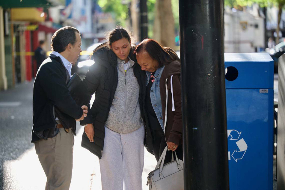 Leticia Harris (c.), whose husband Sergio Harris was killed in the Sacramento mass shooting, and his mother Pamela Harris (r.) speak with police detective Konrad VonSchoech.