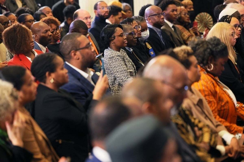 People attend a press conference and signing of legislation to create a New York State reparations commission on December 19, 2023.