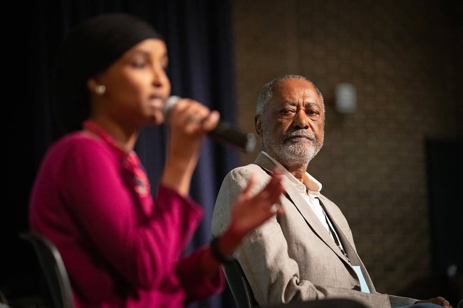 Democratic primary challenger Don Samuels (r.) listens to Congresswoman Ilhan Omar (l.) during the Q&amp;A portion of the Minnesota fifth congressional district's DFL endorsing convention at South High School in Minneapolis.