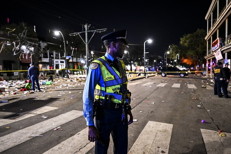 Police officers work at the scene of a shooting that occurred during the Krewe of Bacchus parade in New Orleans on February 19, 2023.