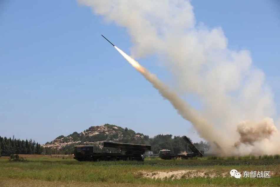 China's People's Liberation Army conducts a long-range live-fire drill into the Taiwan Strait.