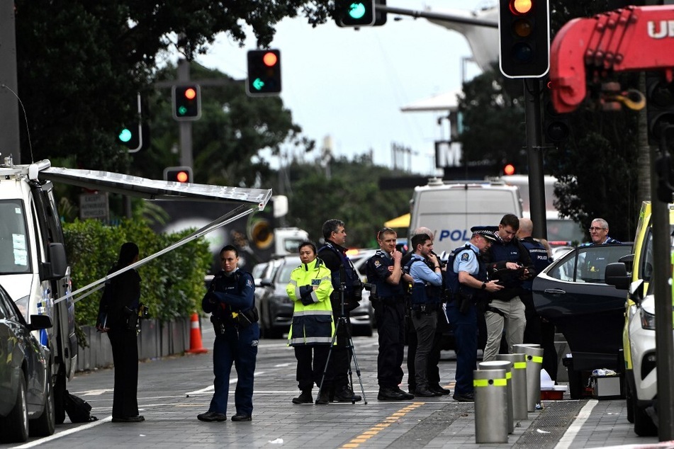 Police officers cordon off an area near the site of a shooting in central Auckland on July 20, 2023.