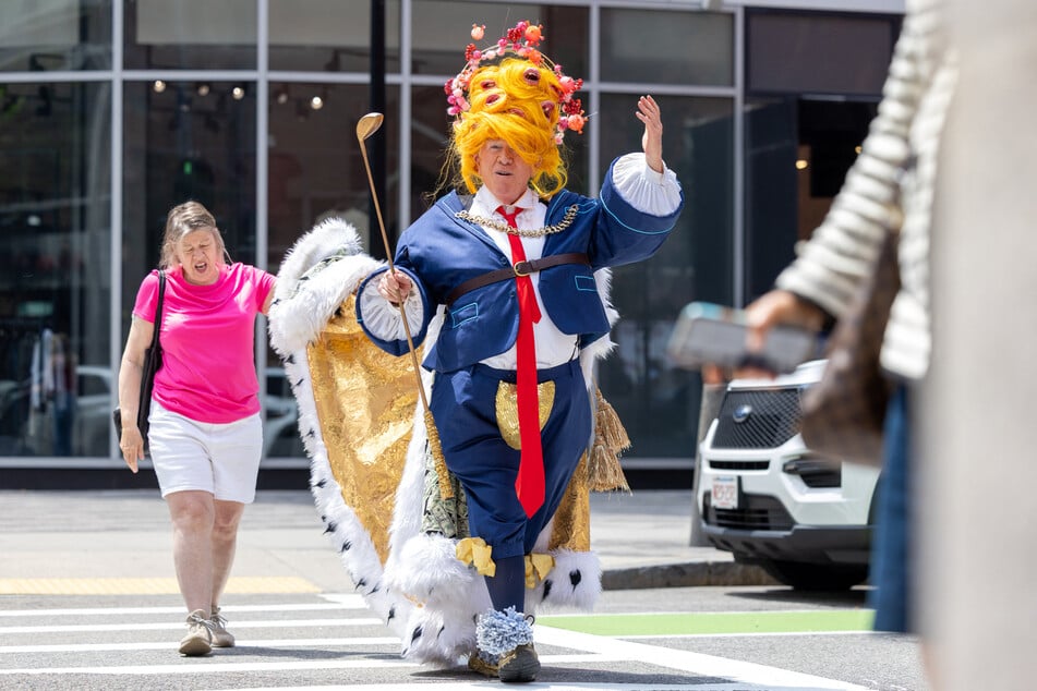 A person dressed as Donald Trump approaches a group of protestors outside of the John Joseph Moakley US Courthouse on Monday in Boston, Massachusetts.