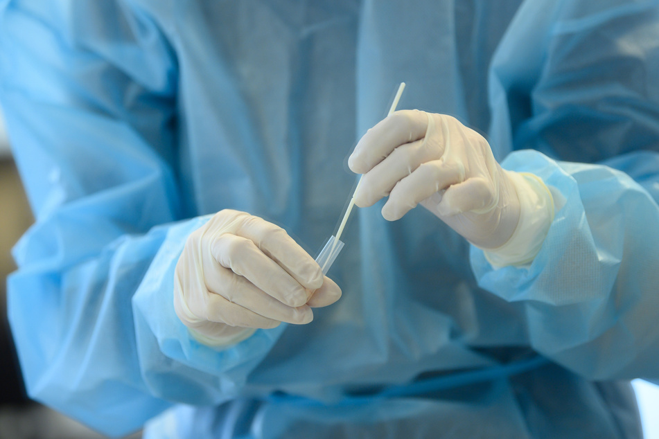 Sachsen, Dresden: Eine Mitarbeiterin in einem Friseurstudio wertet einen Antigen-Schnelltest auf das Coronavirus aus.