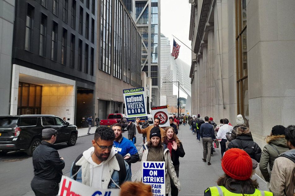 Workers picket in front of the HarperCollins headquarters at 195 Broadway.