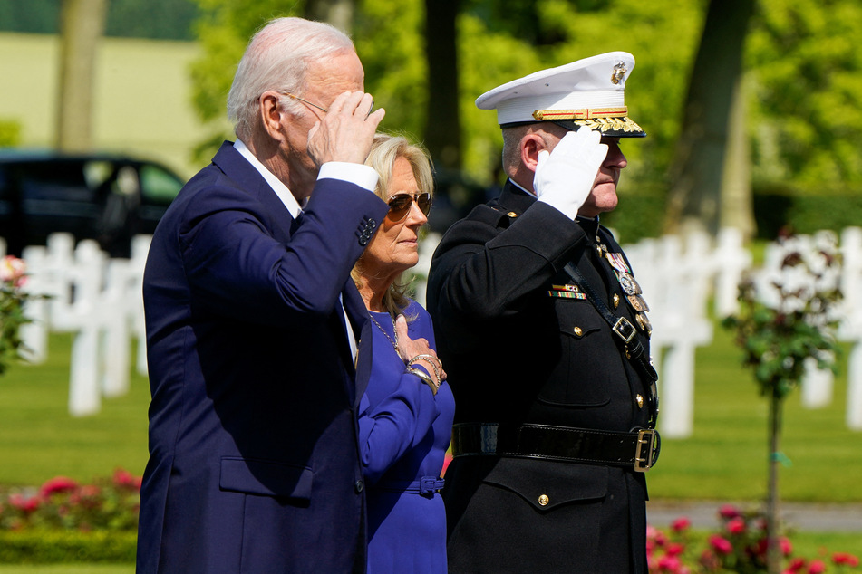 President Joe Biden and first lady Jill Biden salute at the Aisne-Marne American Cemetery in Belleau, France.