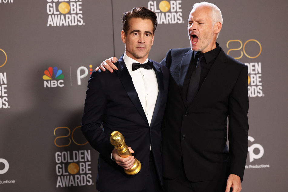 Director Martin McDonagh and Colin Farrell pose with their award for Best Motion Picture in a Musical or Comedy for The Banshees of Inisherin at the 80th Annual Golden Globe Award.