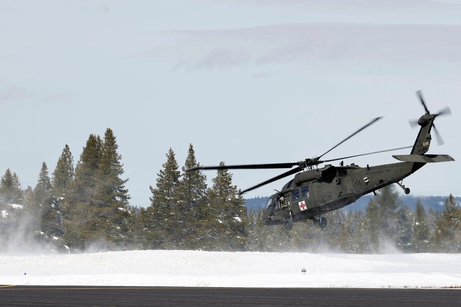 A military helicopter lifts off from Truckee Tahoe Airport on February 21, 2026, while taking part in recovery efforts for the skiers that died in an avalanche in the Sierra Nevada mountains.
