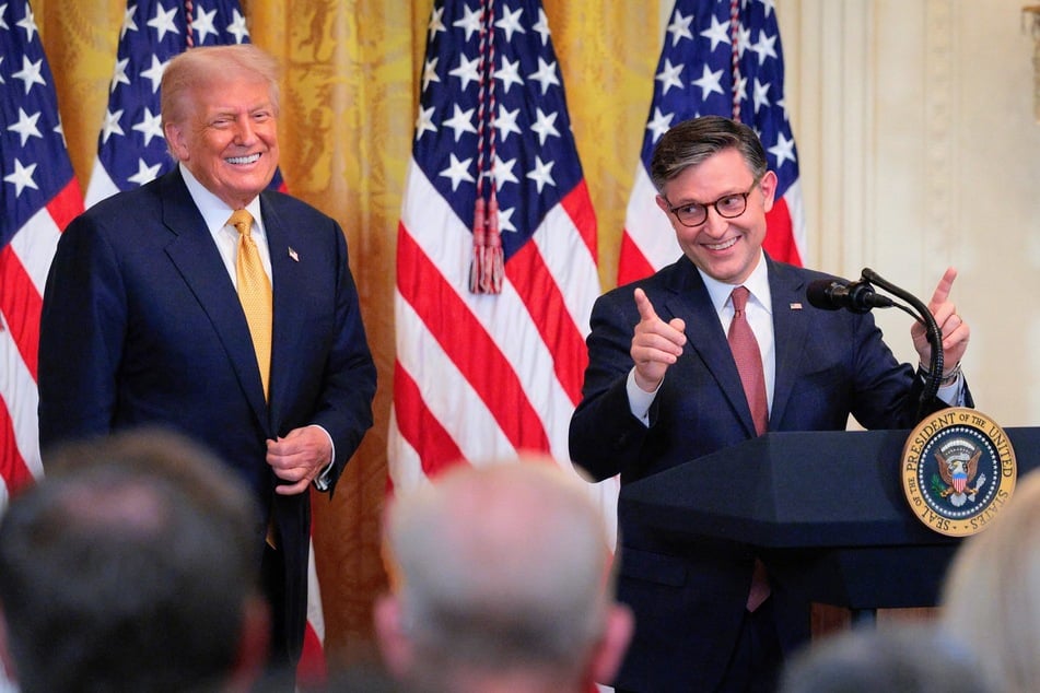 House Speaker Mike Johnson (r.) and President Donald Trump (.) speak during a reception for Republican members of the House at the White House in Washington DC on July 22, 2025.