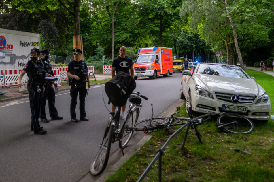 Die Räder liegen zum Teil zerbrochen vor dem Cabrio.