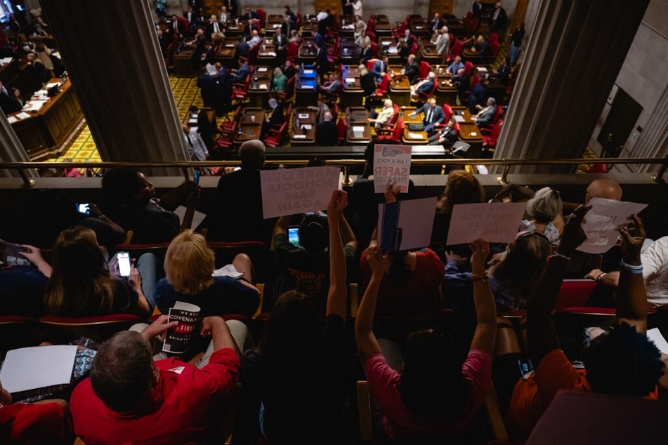 Spectators in the gallery of the House chamber wave signs calling for gun reform during a special legislative session on public safety at the Tennessee State Capitol.
