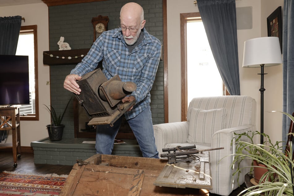 Bill McFarland holds his great-grandfather William DeLyle Frisbee's magic lantern slide projector at his home in Jenison, Michigan, on March 31, 2026.